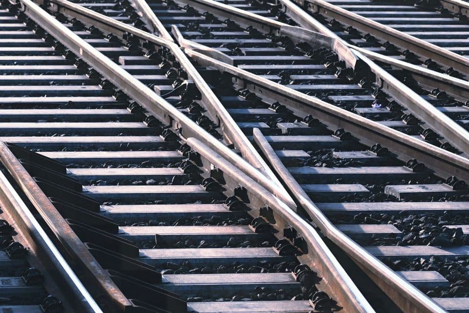 A railway junction photographed from above, several tracks crossing and diverging through a set of switch points