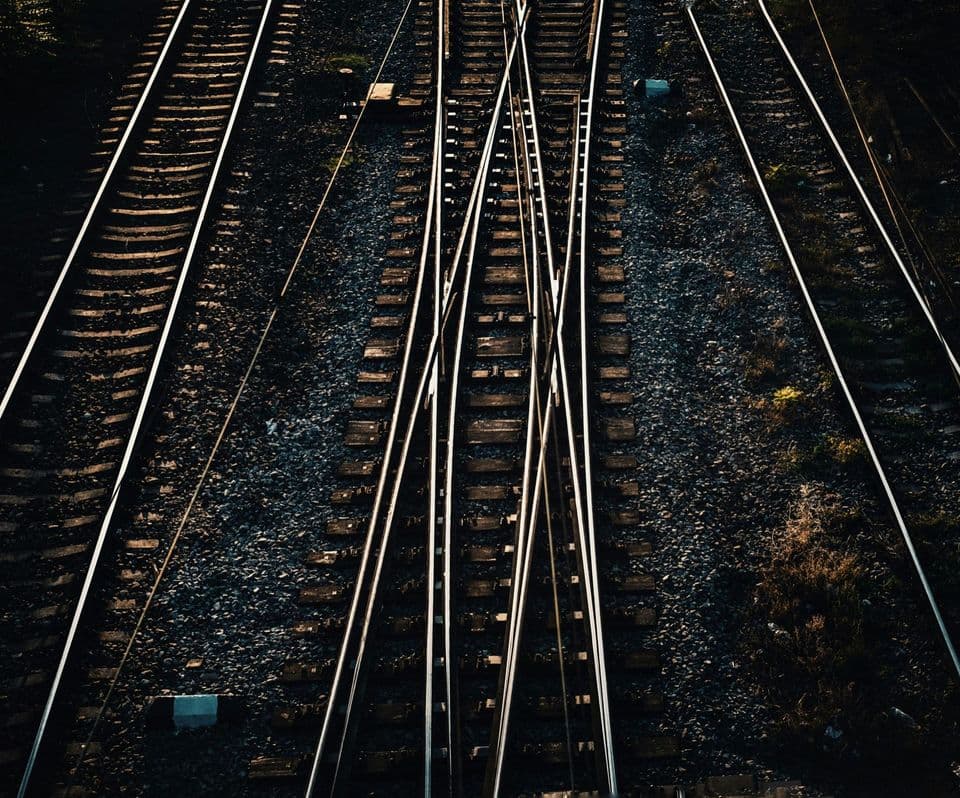 Railway tracks photographed from above, several parallel lines running through a set of switches where the rails cross